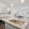 Designer islands with deep farmhouse sinks blend luxury with practicality.