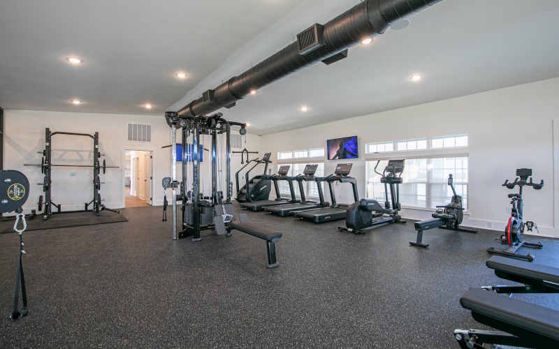 a gym with exercise equipment and windows