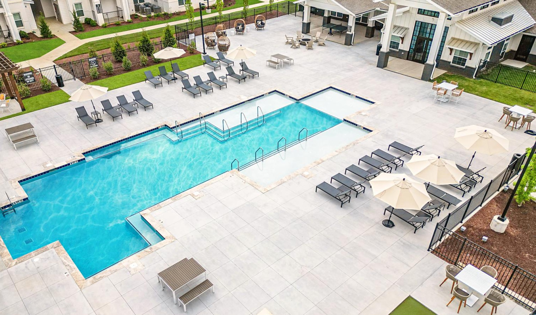 A pool deck surrounded by tanning beds