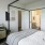 a bedroom with a bed and a mirror