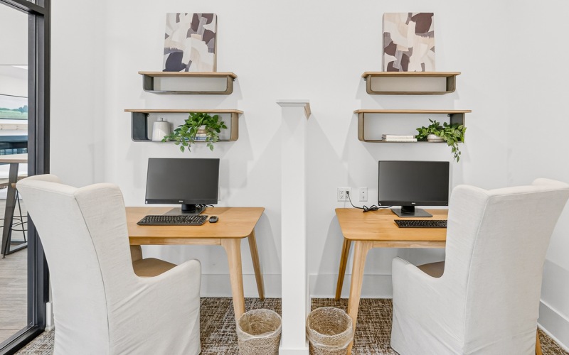 two desk with computers and chairs