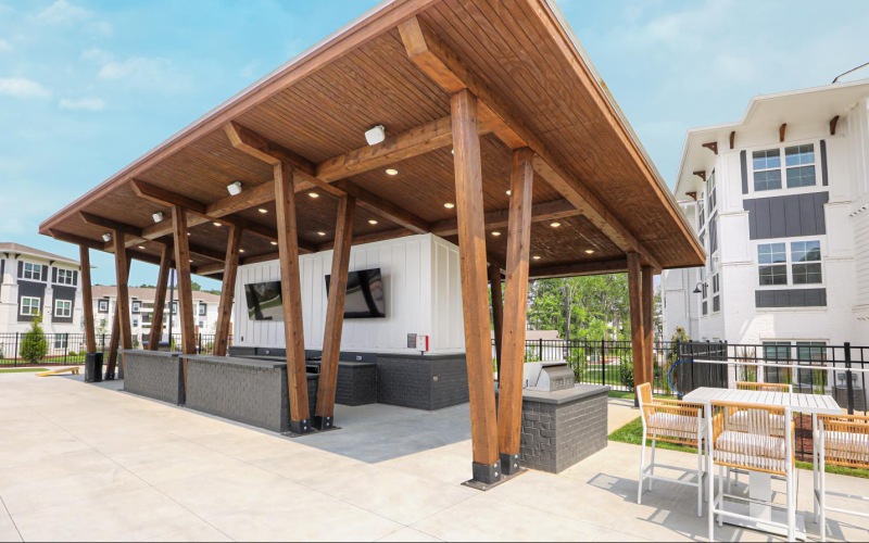 a covered patio with a table and chairs